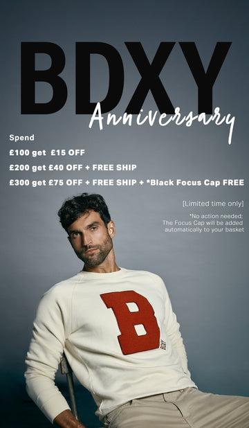 Promotional poster for BDXY with a man wearing a white sweater with a red 'B' and text about discounts and free items.