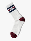 White sock with red toes and heel, blue and red stripes, and a logo on a white background